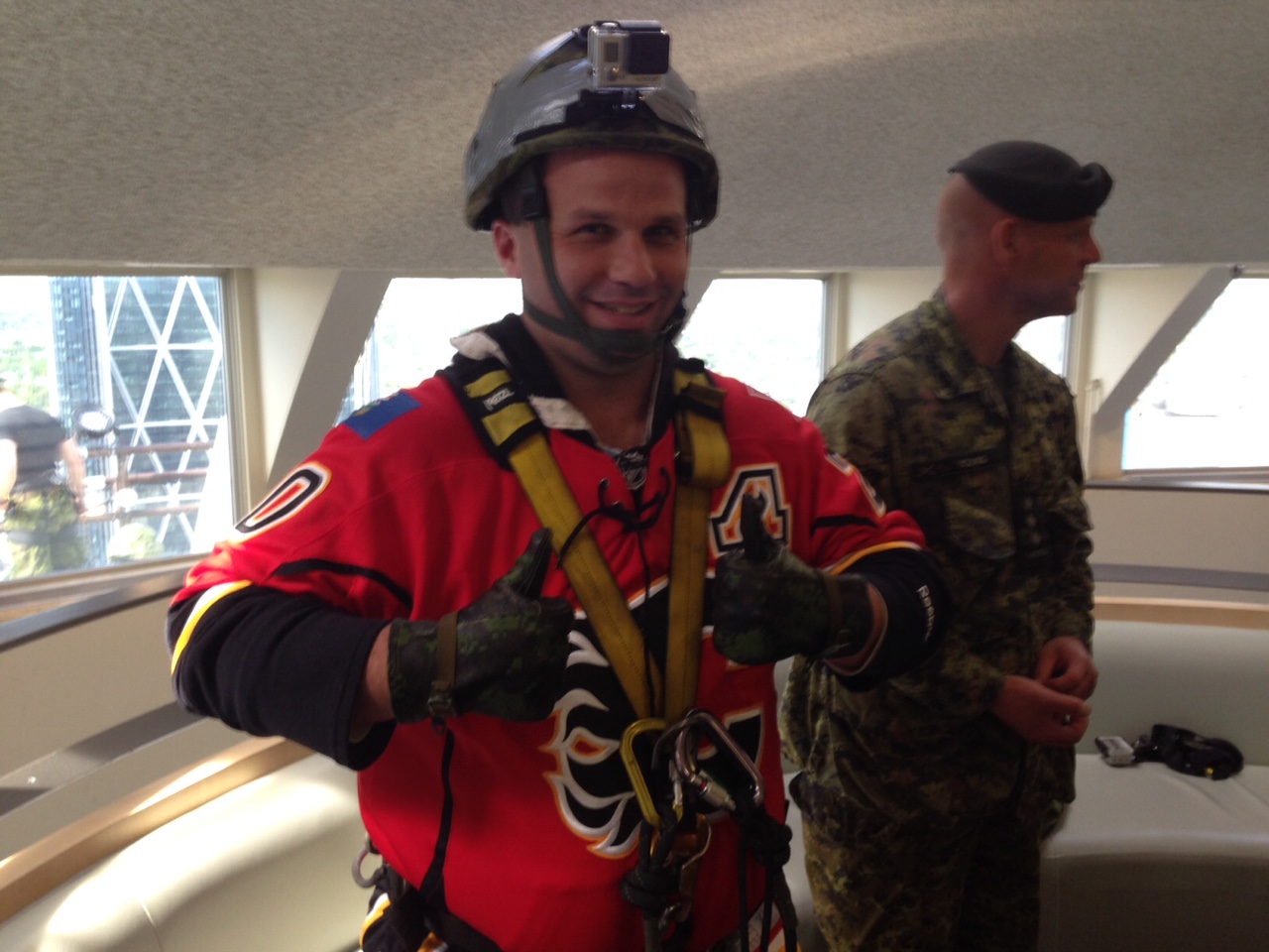 Canadian military members rappel from the roof of the Rogers