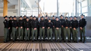Minister Nixon stands with Alberta's newest conservation officers following their badge ceremony.