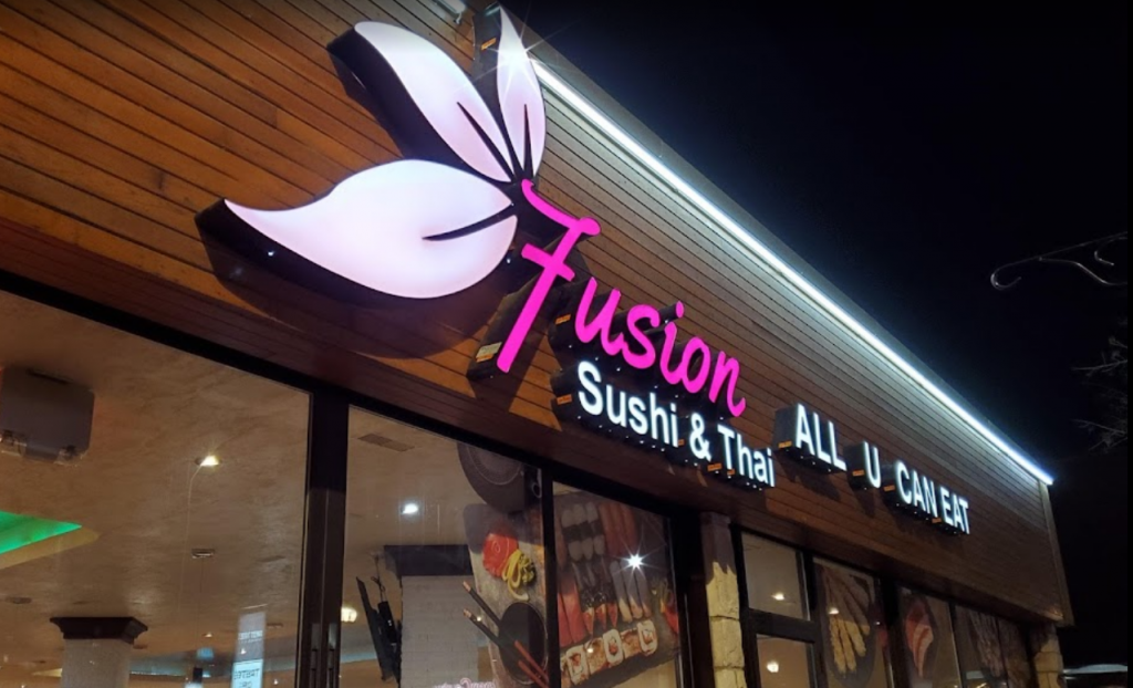 Fusion Sushi sign with wooded background along 17 Avenue in Calgary