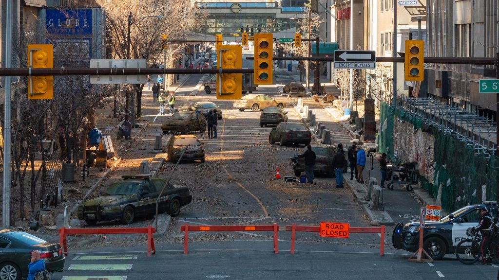 A road scattered with cars in downtown Calgary for the Last of Us shooting