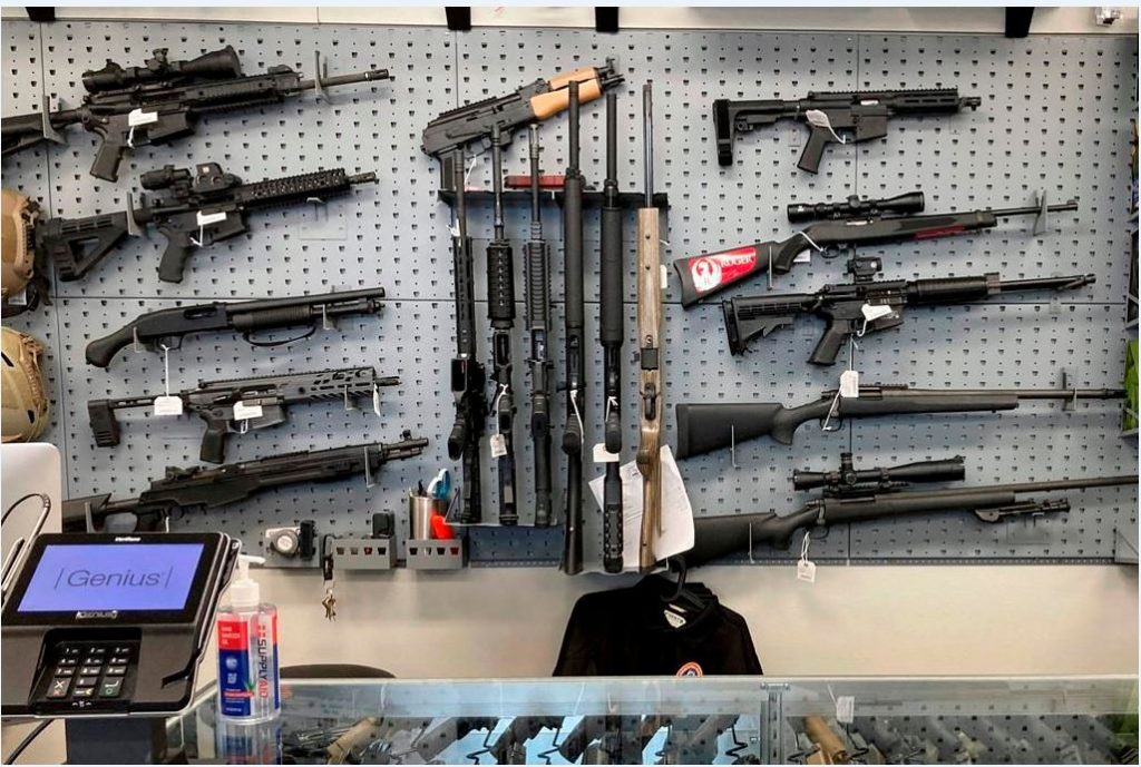 rifles are displayed in a gun shop in Salem, Ore. On Friday, March 12, 2021, The Associated Press reported on stories circulating online incorrectly asserting proposed federal gun legislation expanding background checks for firearms would create a “national registration of firearms” and put gun owners in jail for transferring or handing their gun to someone, even if they are in a dangerous situation. But the bill, H.R. 8, prohibits using the legislation to establish a national firearms registry and includes exceptions that allow temporary transfers of firearms between family members, transfers between people for self-defense and for use at a shooting range. (AP Photo/Andrew Selsky)
