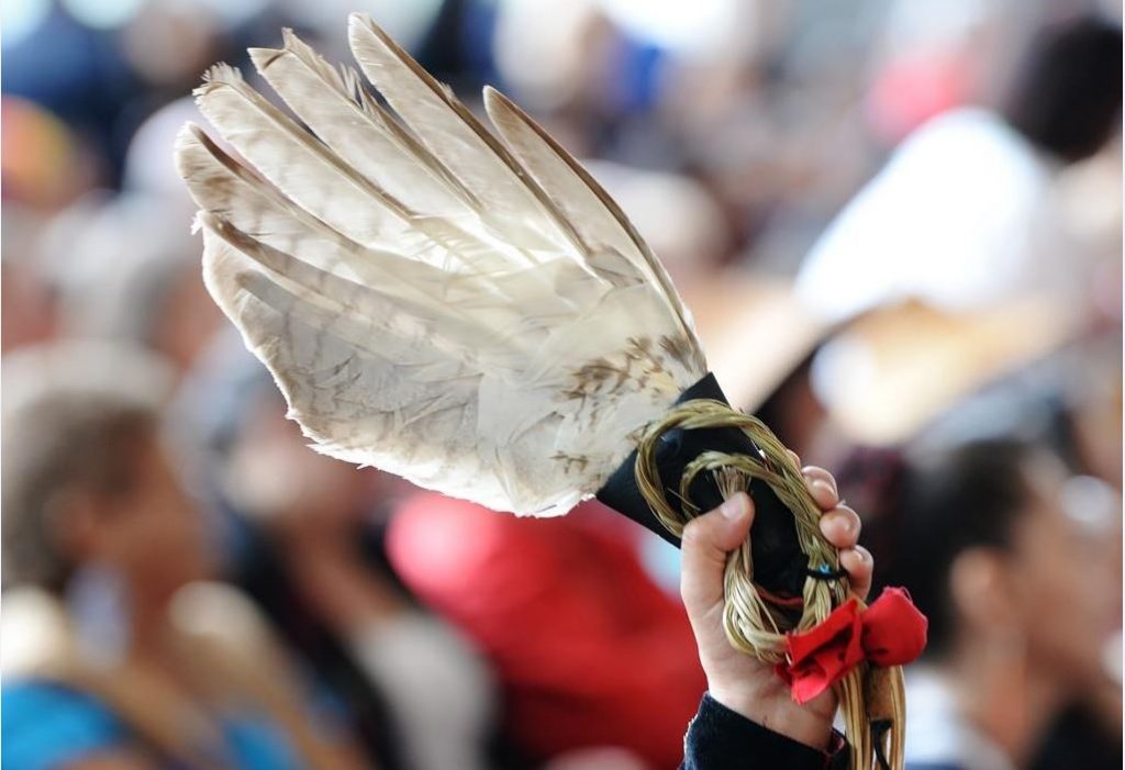 A person holds an eagle feather at the closing ceremony for the National Inquiry into Missing and Murdered Indigenous Women and Girls in Gatineau, Que.,