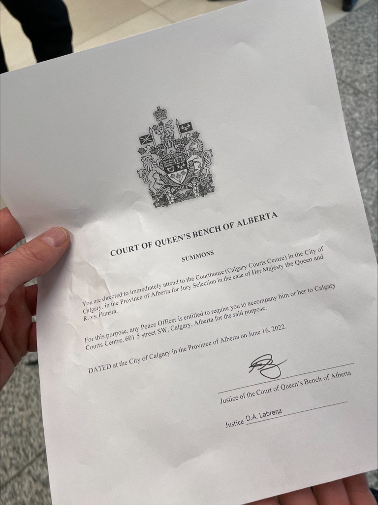 A jury summons issued by the Court of Queen's Bench Alberta is shown.