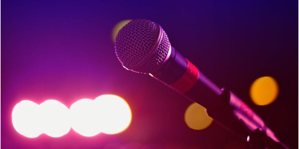 A mic on a stage is shown