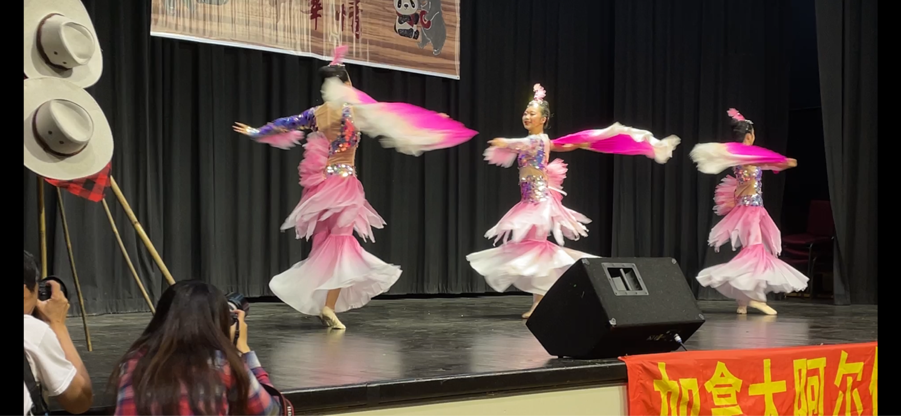 Performers on stage at the Calgary Chinese Cultural Association showcase during Stampede