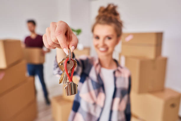 Woman's hand showing keys from new apartment.