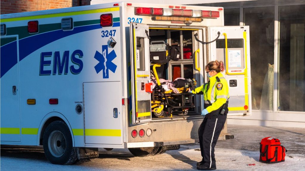 A paramedic loads a patient into the back of an ambulance in downtown Calgary.