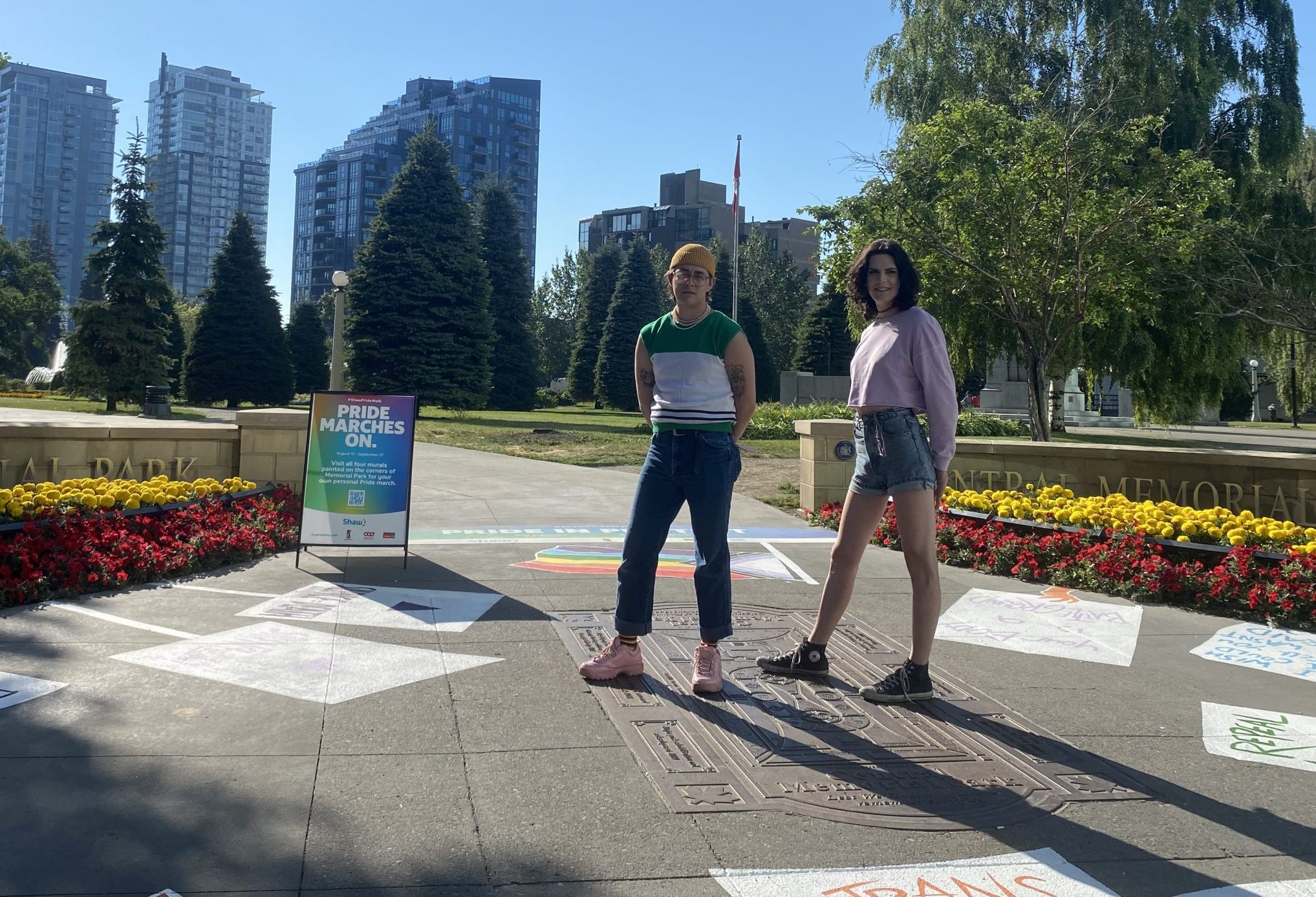 Ryan Danny Owen, left, and Kat Simmers pose with their mural called Pride in Protest in Central Memorial Park in Calgary