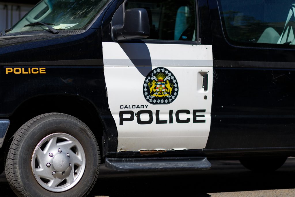 A Calgary police van and their emblem on Stephen Avenue in downtown Calgary