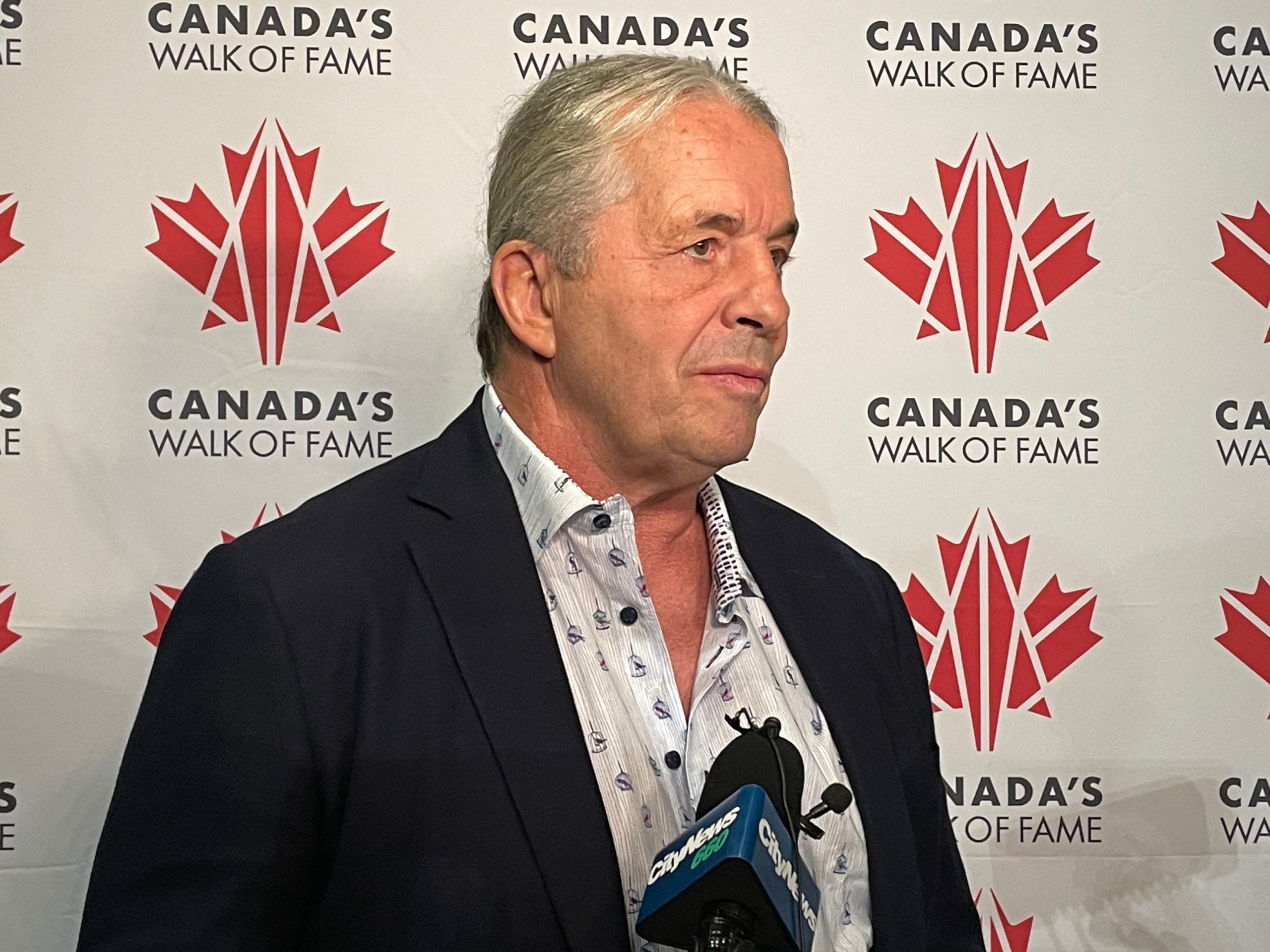 Bret 'Hitman" Hart speaks to reporters after receiving a replica plaque of his star on Canada's Walk of Fame at the Victoria Pavilion on Stampede Grounds