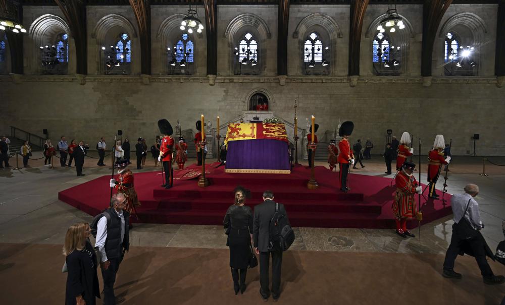 a picture of members of the public file past the coffin of Queen Elizabeth II