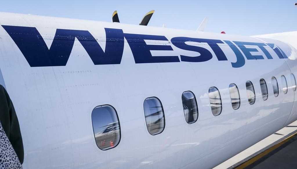 The WestJet logo on the side of an aircraft