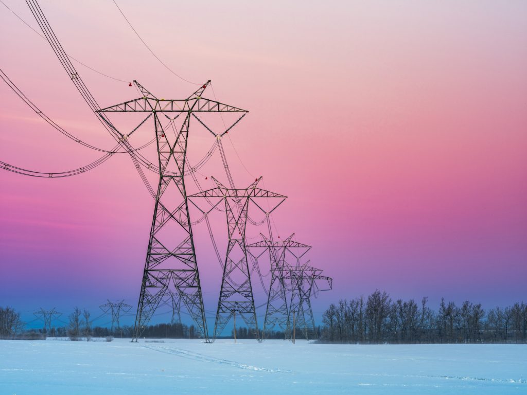 Sunrise of prairie with power line in the winter in Alberta, Canada.