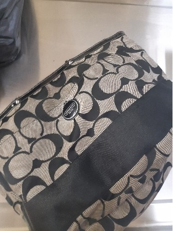 A large black and grey Coach purse