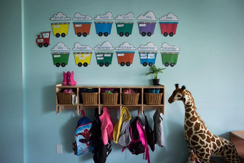 a picture of children's backpacks and shoes are seen at a daycare