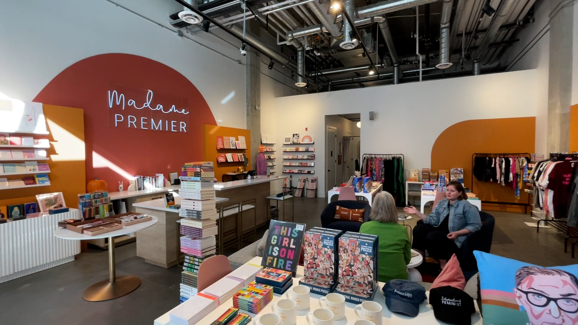 The inside of Madame Premier where Sarah Elder-Chamanara sits with someone else in the Inglewood community in Calgary