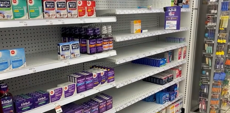 Shelves at a drugstore where children's cold and flu medication should be are bare.