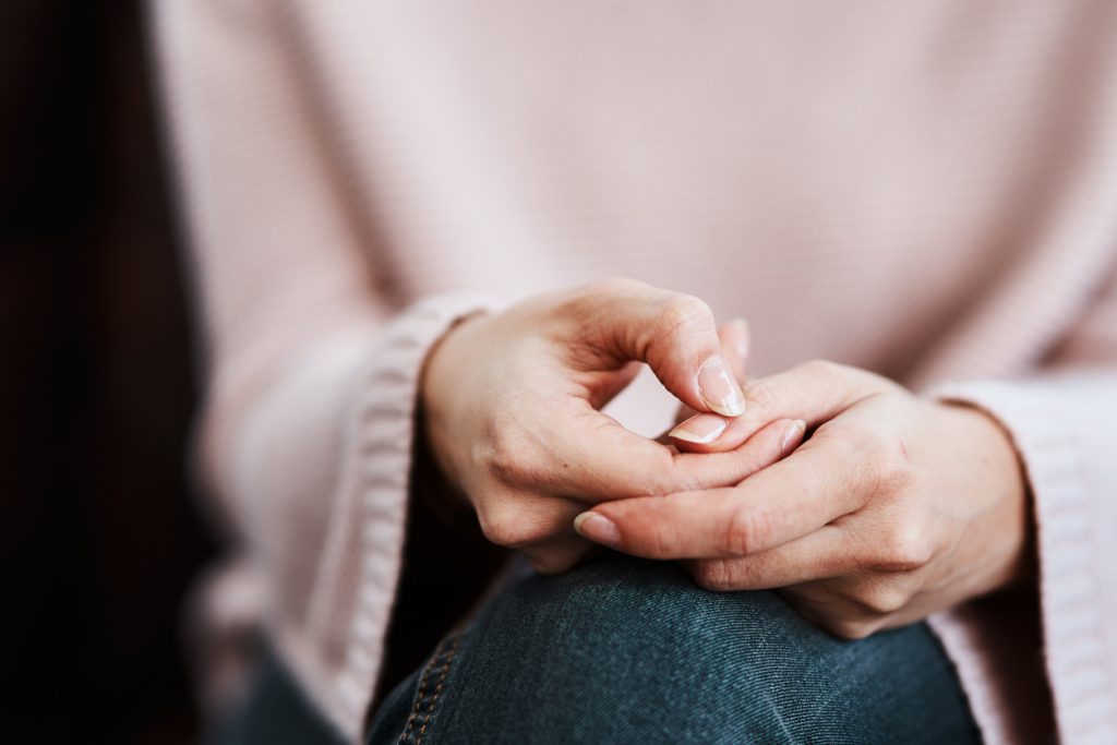 a picture of the hands of a nervous domestic violence survivor.