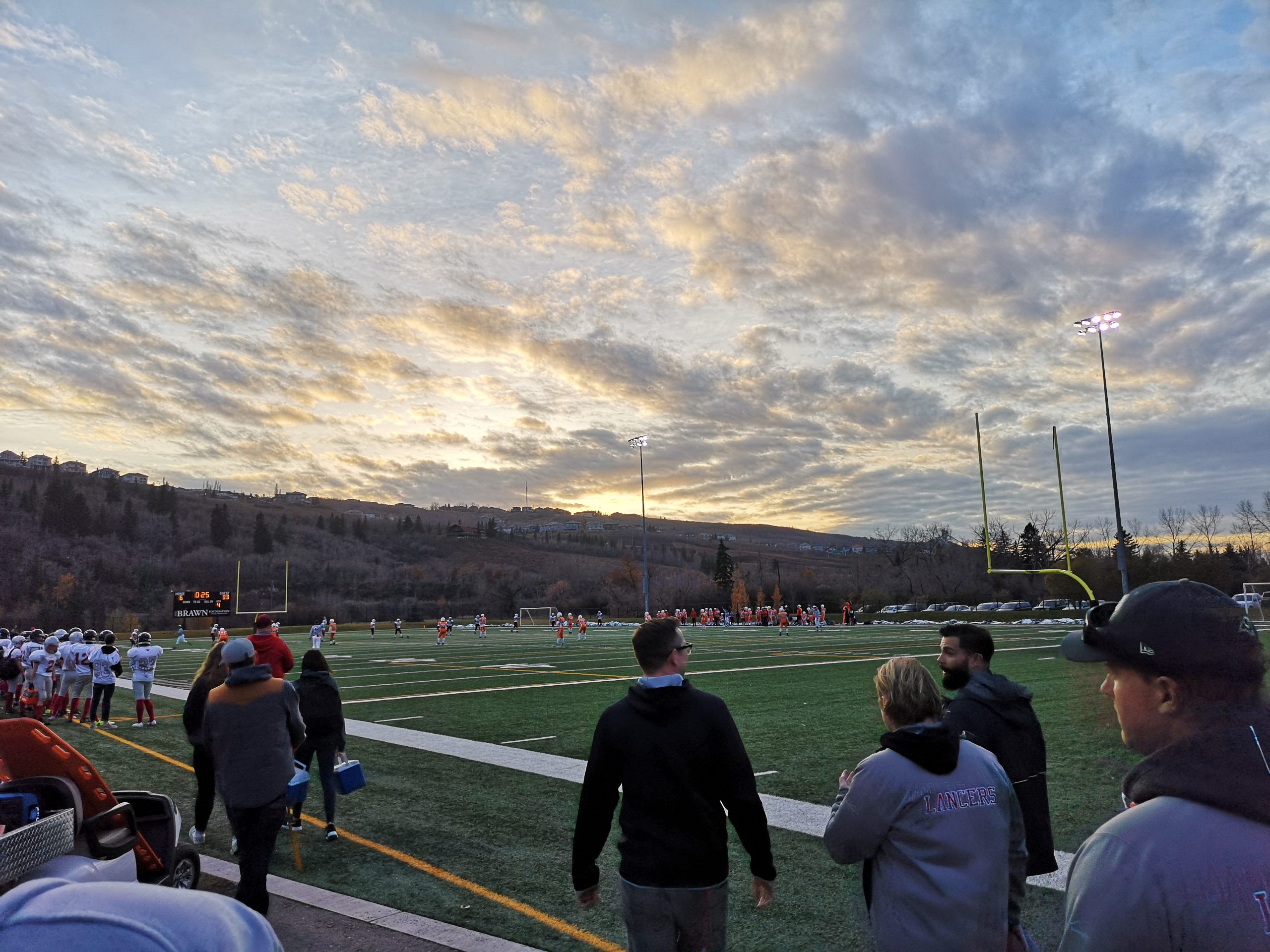 The sun starts to set at Encana Field while a football game takes place in Calgary