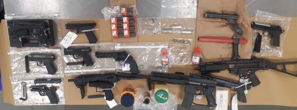 An assortment of firearms seized by Calgary police lie on a table
