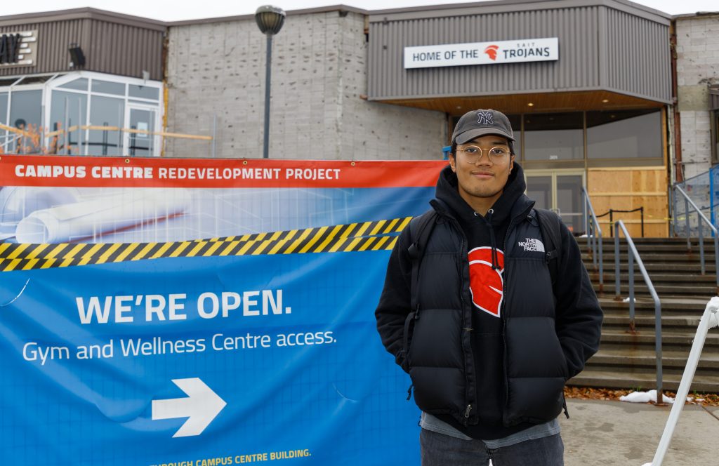 Jeff Carreos poses in front of the only entrance to Campus Centre on SAIT campus in Calgary