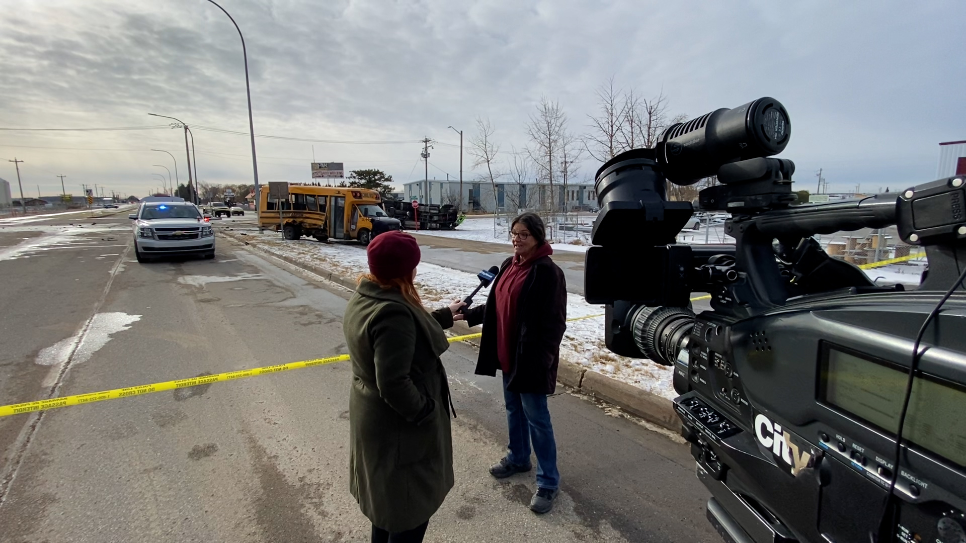 Chris Heyligers, right, speaks with Carly Robinson at the scene of a school bus crash in Spruce Grove west of Edmonton