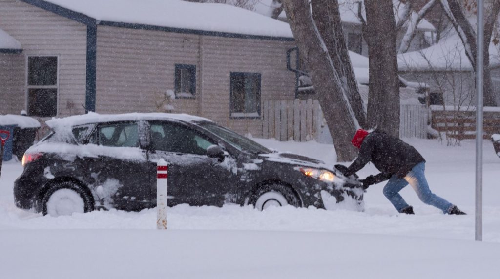 A massive dump of snow left people struggling to get around Calgary, like this car stuck on the road in Inglewood on Dec. 22, 2020.