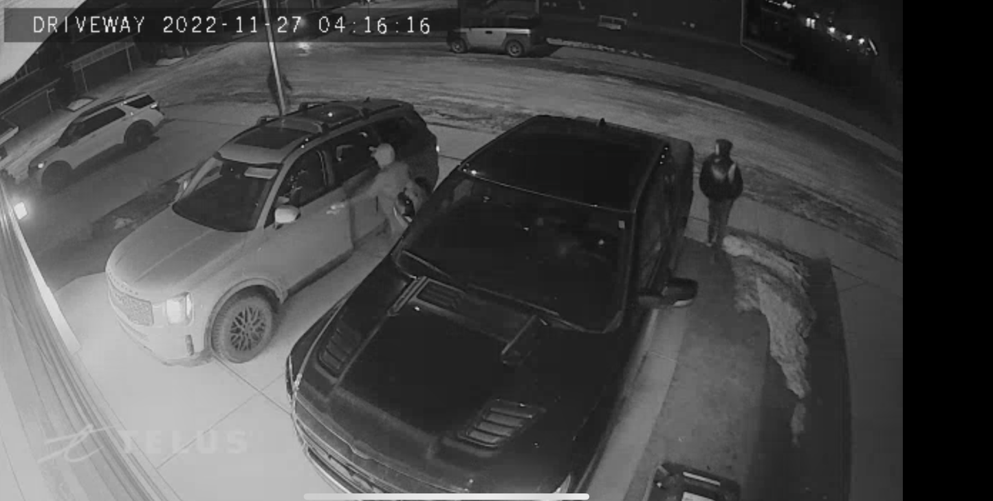 A picture showing suspects one and three leaving with victim's cars 