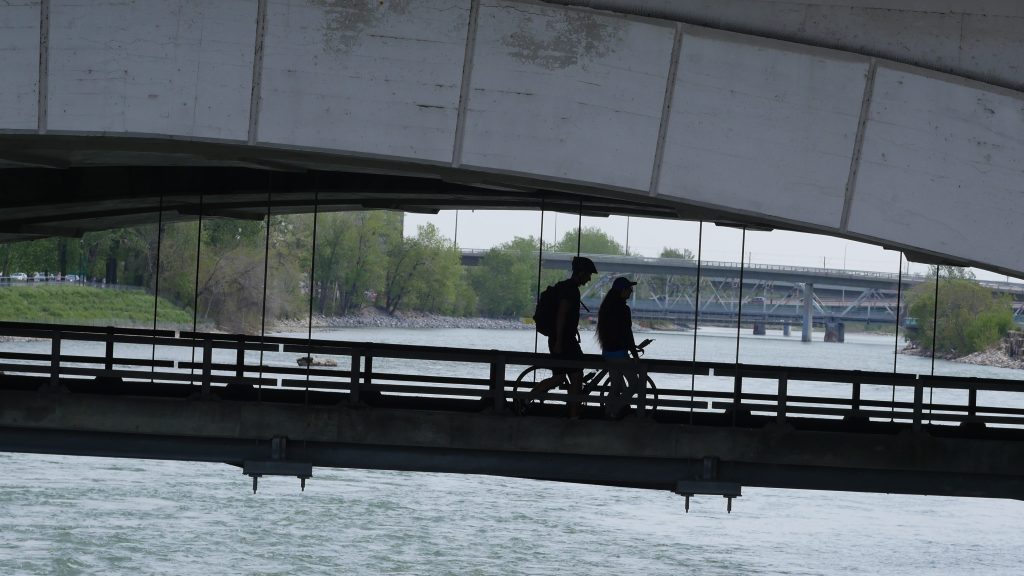 People walking on the lower deck of the Centre Street Bridge in SE Calgary