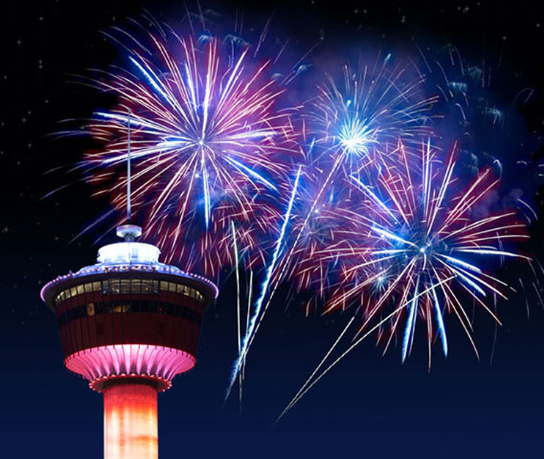 A photo showing fireworks behind the Calgary Tower