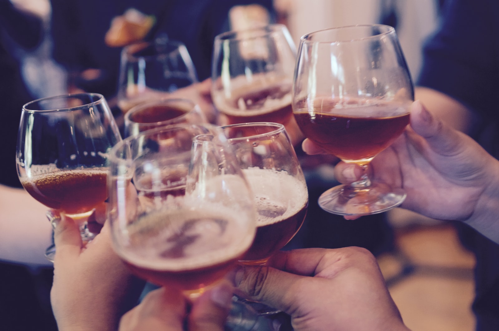 People hold glasses up at a party