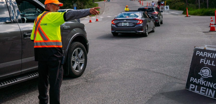 A man points in another direction while he directs traffic