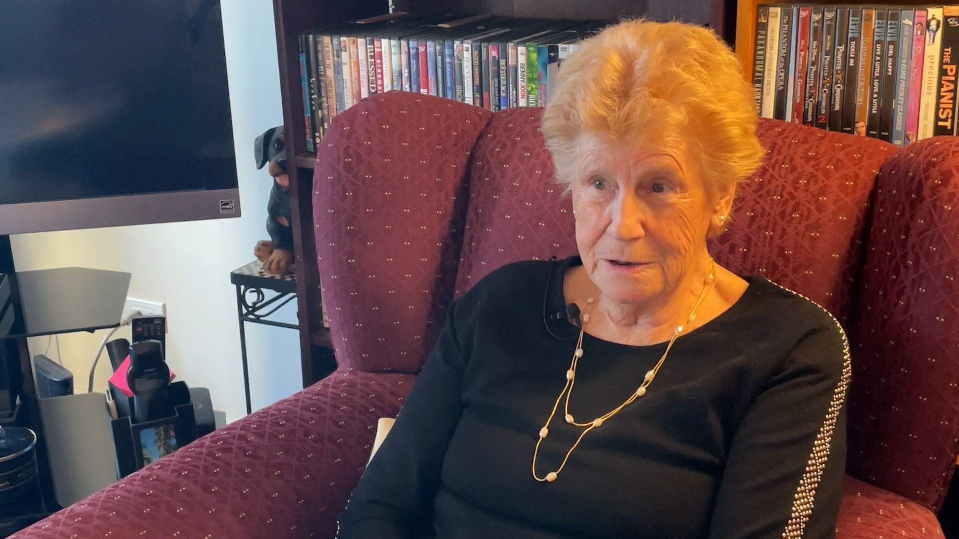 Inger Pederson sits on her chair in her living room