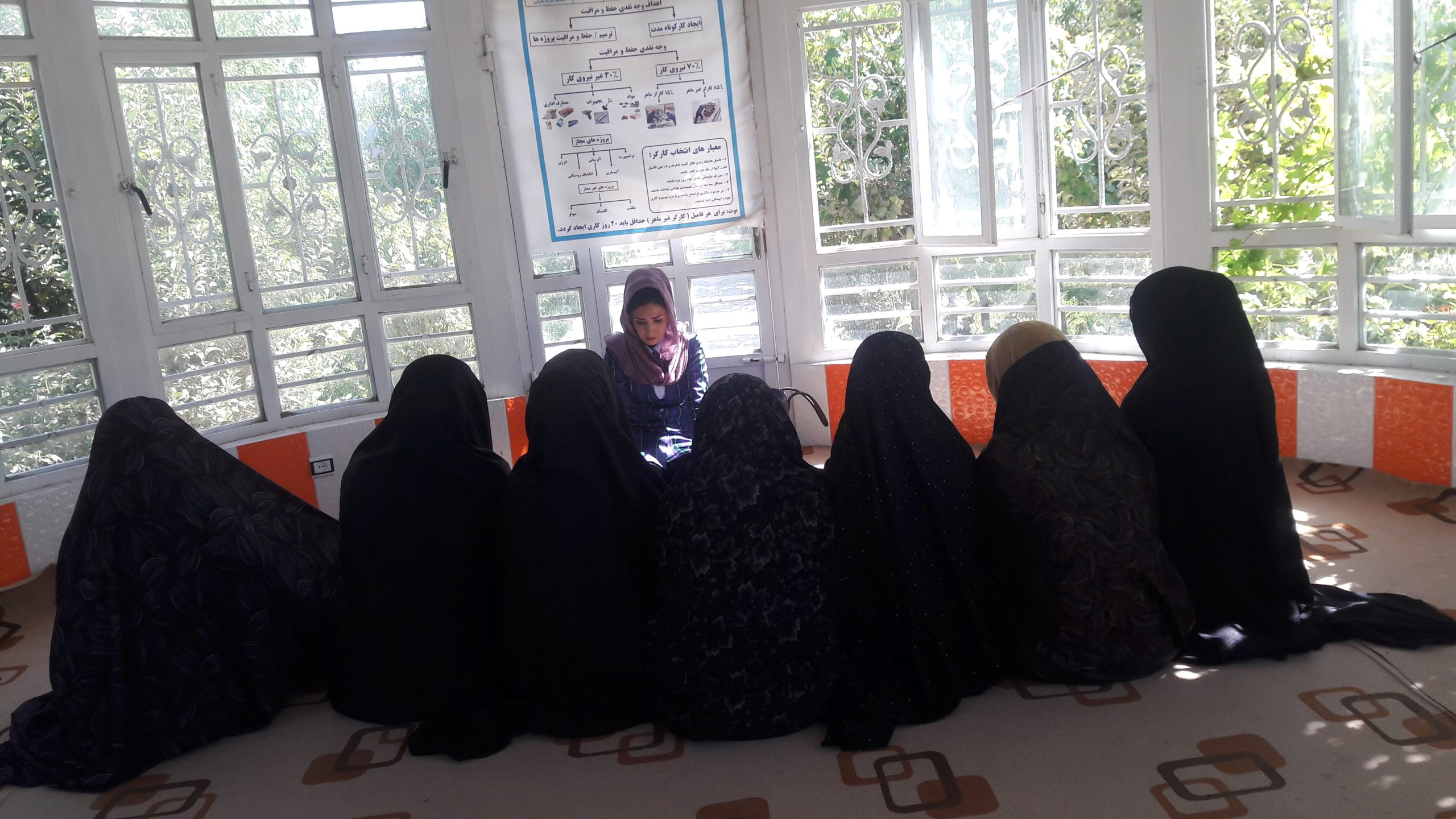 Fatima Roshanian, centre, speak with a group of women in the Herat province in Afghanistan