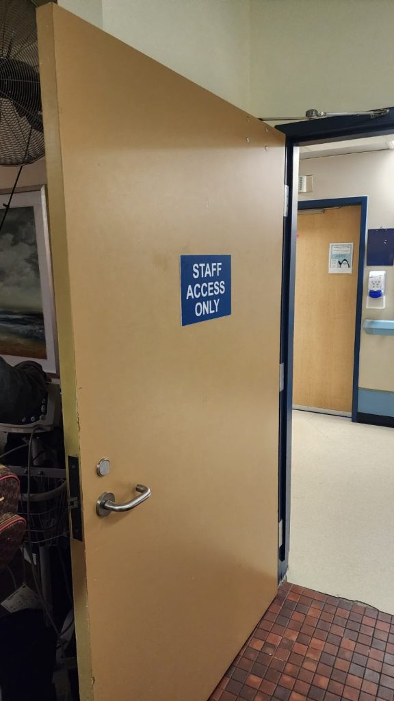 The door to a room labeled "Staff Access Only," where Bradford Mistaken Chief's mother stays while at the Tom Baker Cancer Centre in Calgary