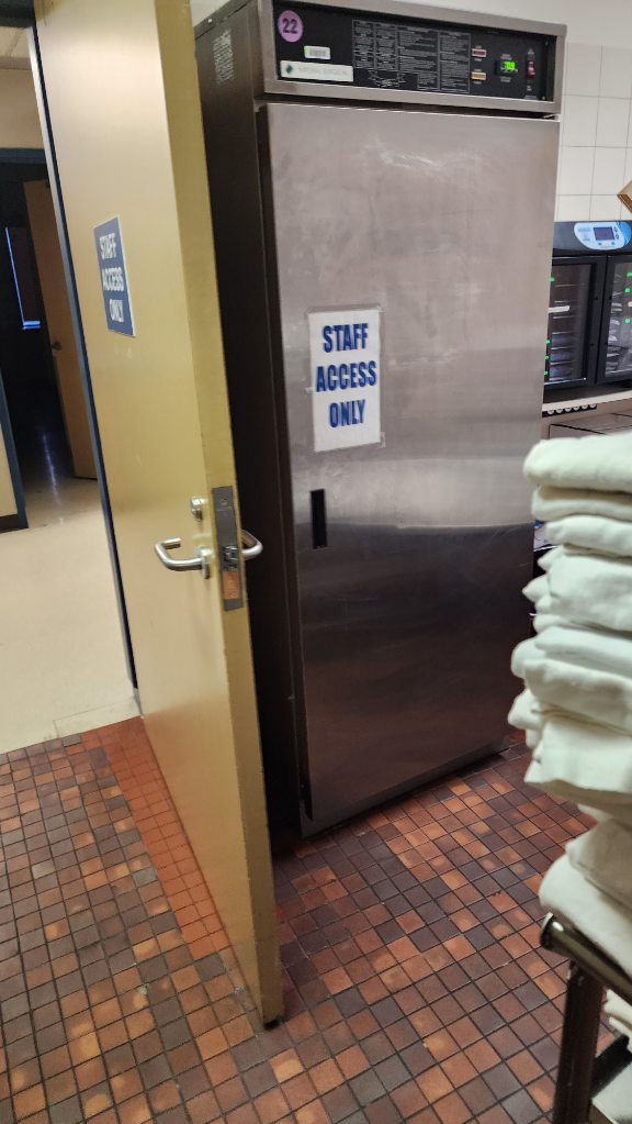 The door to a room labeled "Staff Access Only," where Bradford Mistaken Chief's mother stays while at the Tom Baker Cancer Centre in Calgary