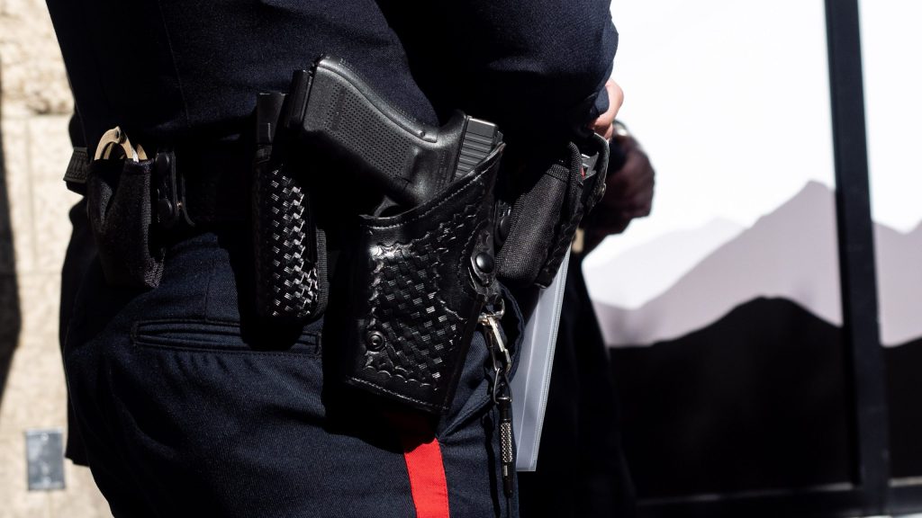 Calgary police Chief Mark Neufeld's service weapon sits in his holster during an event in downtown Calgary