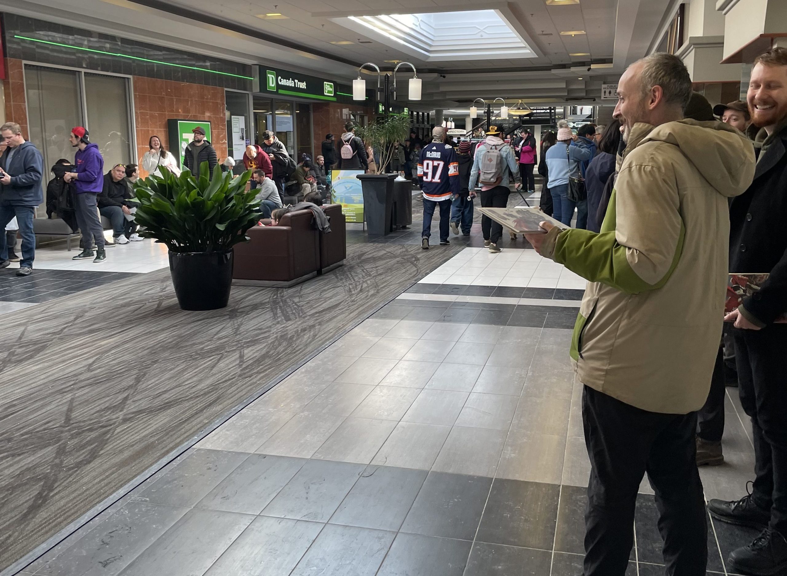 People outside Video Game Trader inside the Lake Bonavista Promenade shopping mall in Calgary