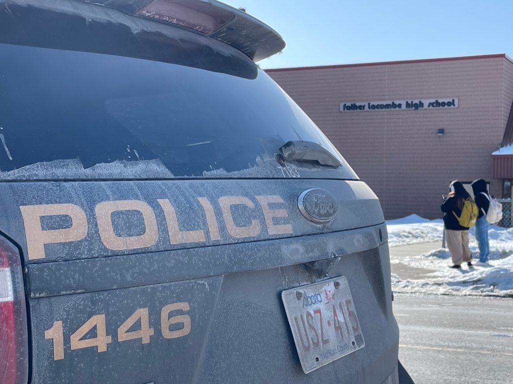 A Calgary Police Service cruiser sits in front of Father Lacombe High School in southeast Calgary