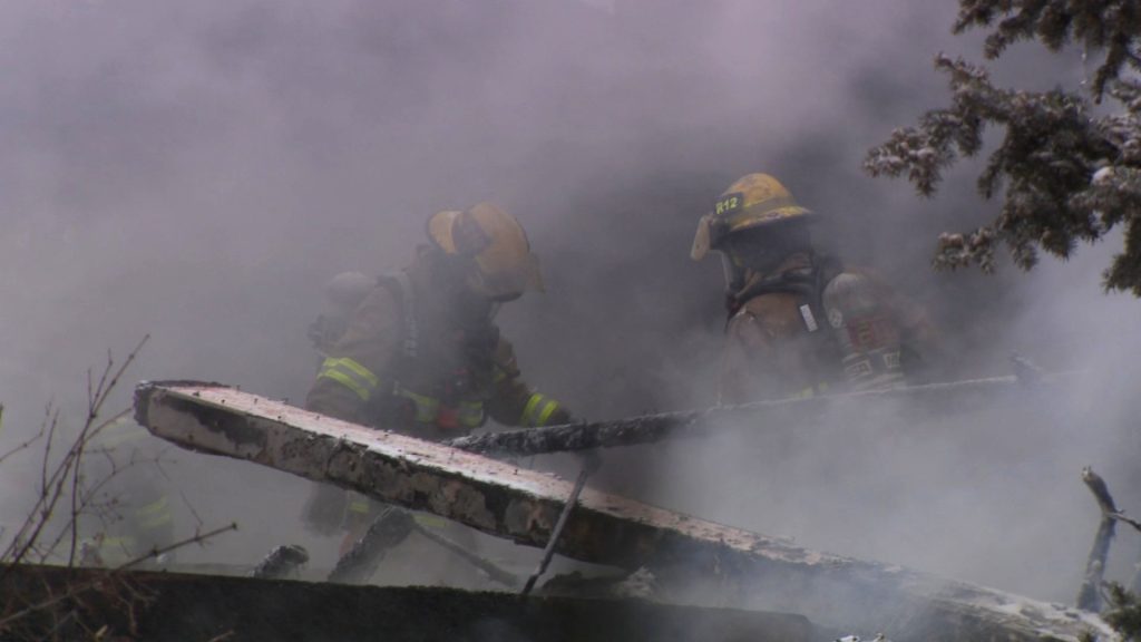 A pair of Calgary firefighters at the scene where a home was destroyed in an explosion in northeast Calgary