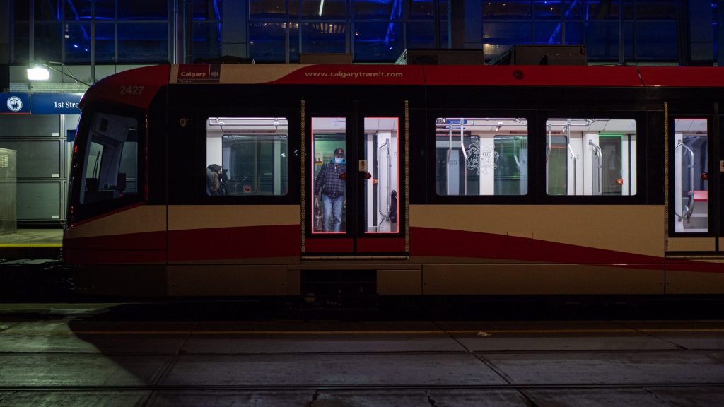 A CTrain stops at a downtown Calgary station in the evening