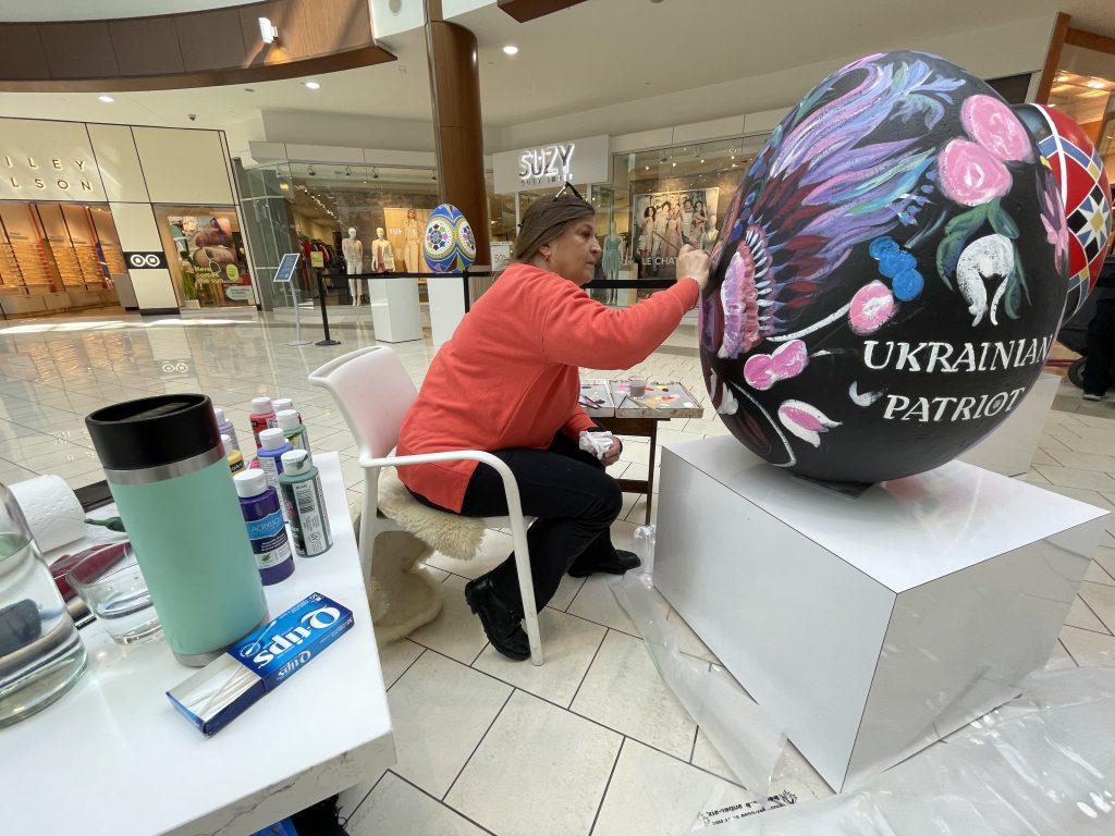 Local Ukrainian artist, Tanya Sotnikow, puts the last touch on her Pysanky egg named "Ukrainian Patriot" inside Southcentre Mall in Calgary