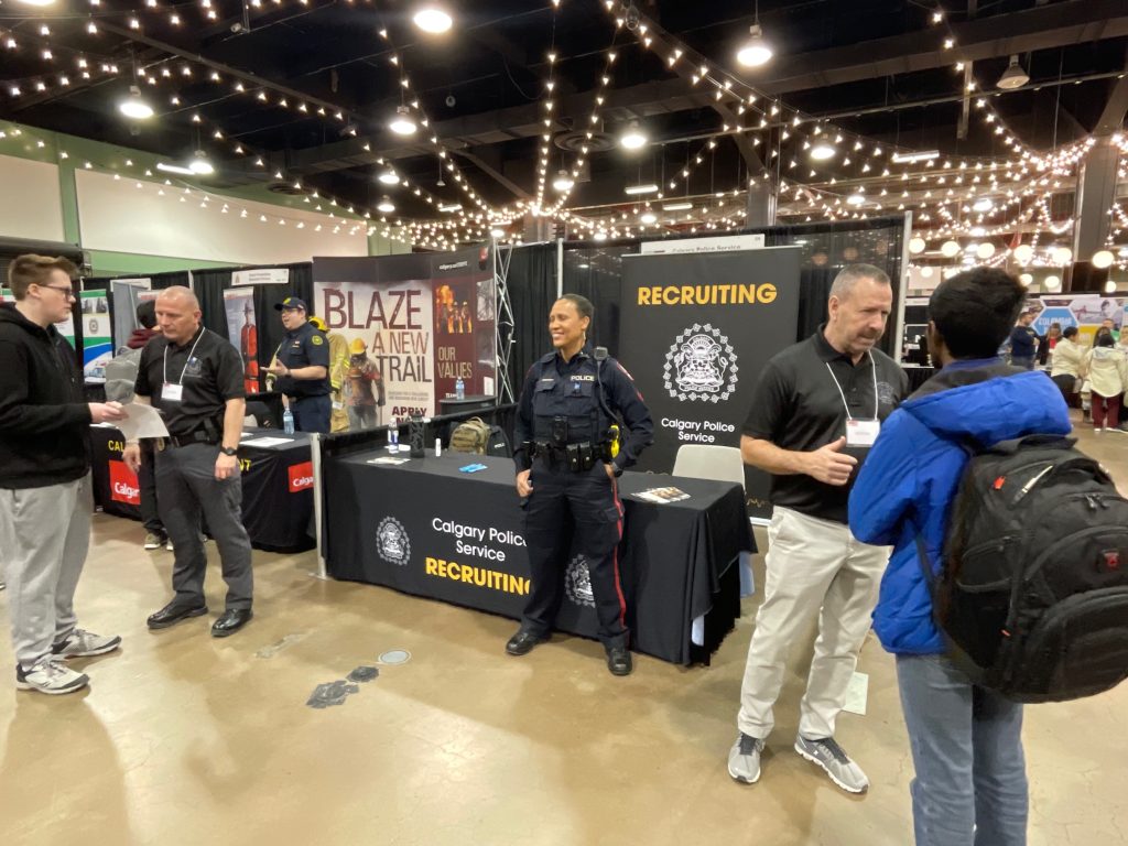 A Calgary Police Service (CPS) officer stands at a booth at the Youth Hiring Fair in Calgary