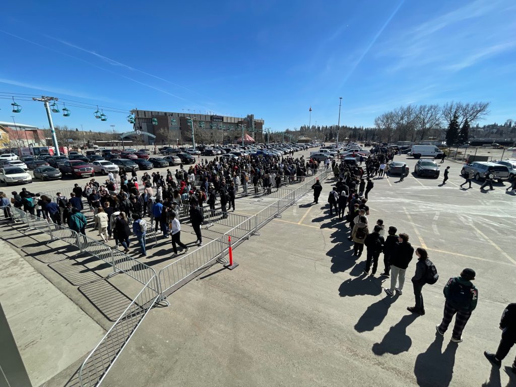 People wait in long lines to attend the Youth Hiring Fair at the Big Four Building in Calgary