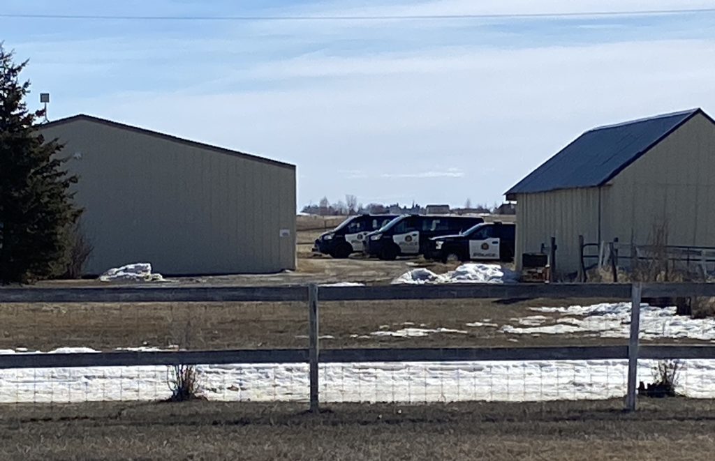Calgary Police Service vehicles at an acreage in Chestermere, Alta