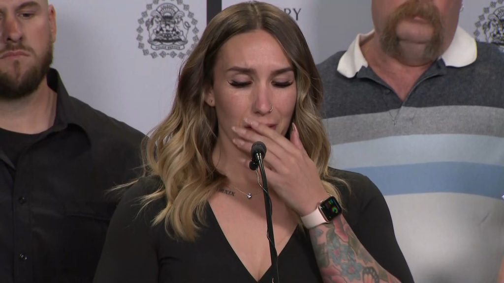 Alyssa Feeney, speaks tearfully to the media in Calgary on Tuesday, May 2, 2023.