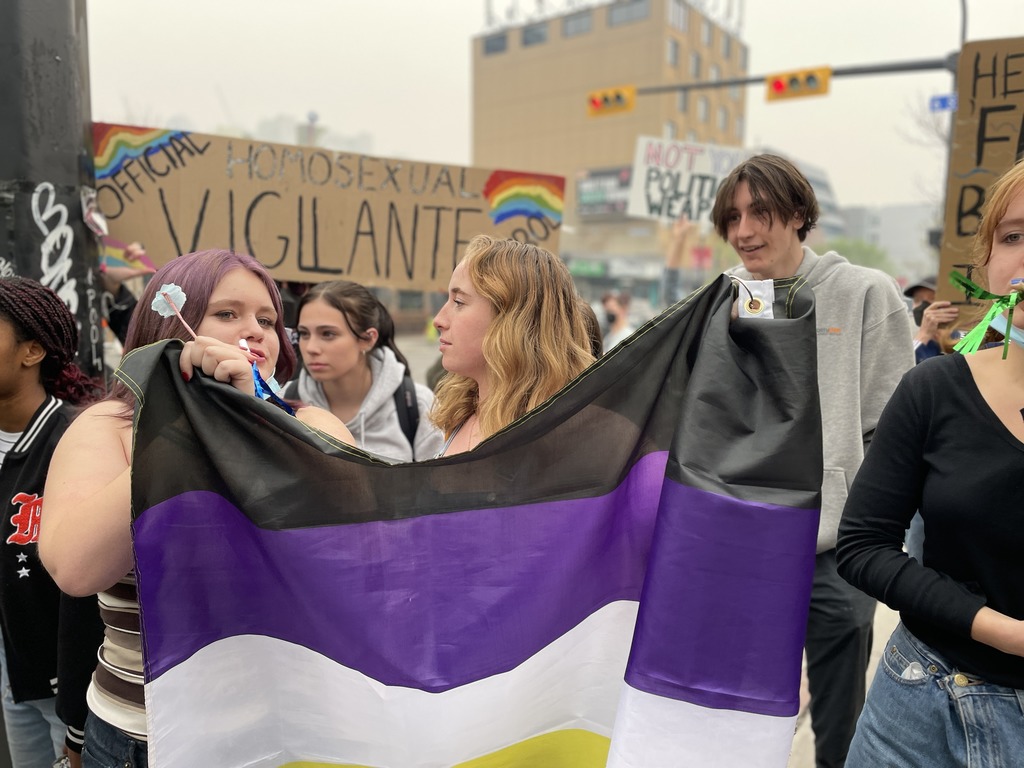 Young people hold signs during a counter-protest outside Calgary's Western Canada High School on Wednesday, May 27, 2023, the International Day for Homophobia, Biphobia and Transphobia. A right-wing media personality chose the city as the location for an event he called an "International Walkout Protest" campaigning against transgender rights in schools. (Nick Blakeney, CityNews image.)