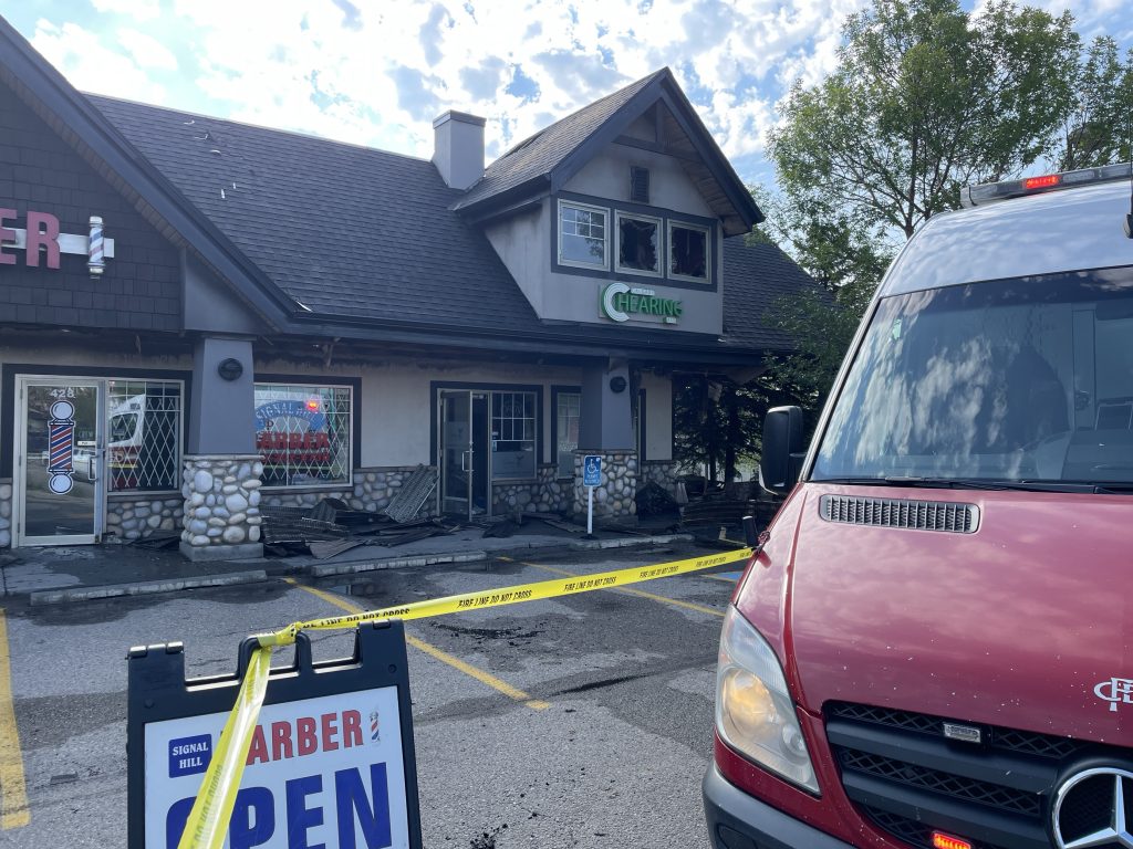 A Calgary Fire Department truck in front of a strip mall on Sirocco Drive SW in Calgary