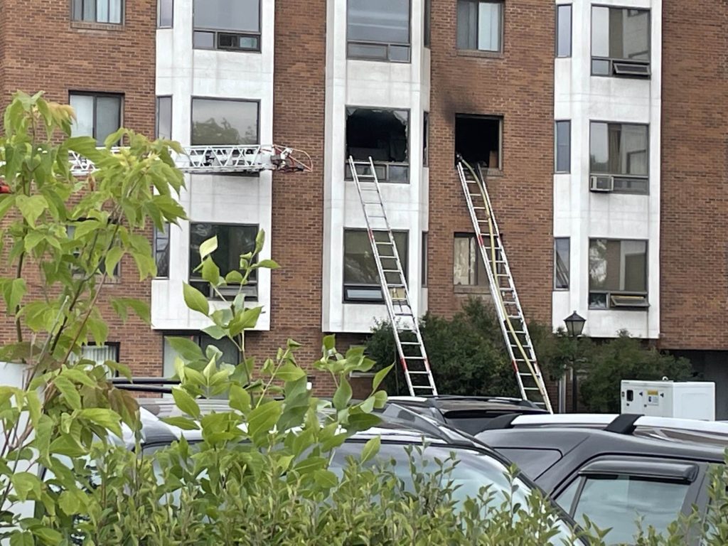 Calgary fire fighters have ladders at windows of Silvera for Seniors - Mountainview Apartments in Calgary