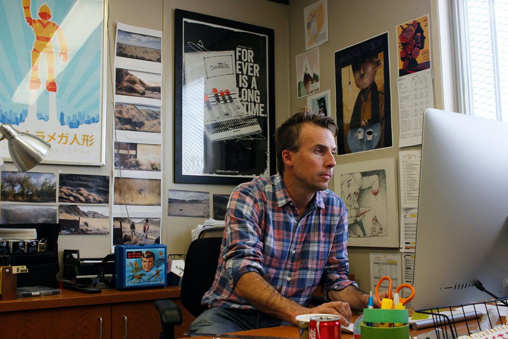 Trevor Smith on his computer inside his office